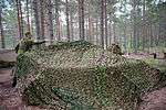 A military vehicle covered in camouflage netting