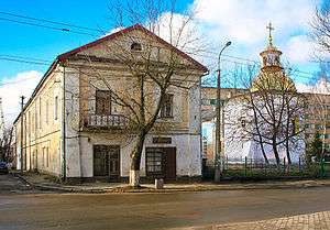 Two-story residence to the left of a church