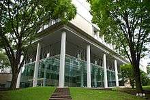 Corner of large white building, with landscaped steps