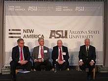 Four people seated at a panel discussion.