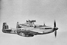 Five World War II-era propeller driven fighters in the air