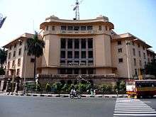 Massive, pinkish-gray building with columns