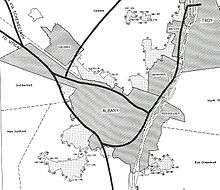 Black and white map shows the boundaries of Albany and surrounding municipalities, crossed with dark black lines representing planned interstate highways.