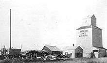 Grain elevator with smaller, adjoining outbuildings