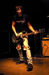 Recording engineer Steve Albini holding a guitar