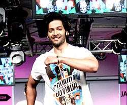 Ali Fazal looking walking on a stage