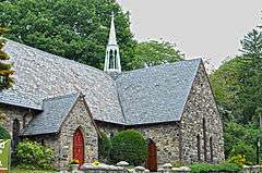 Stone English Gothic-style church with red door