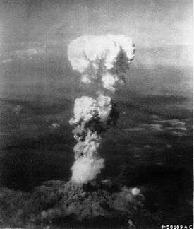 White fragmentred mushroom-like smoke cloud evolving from the ground.