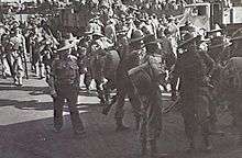 Soldiers at a wharf prepare to embark for overseas