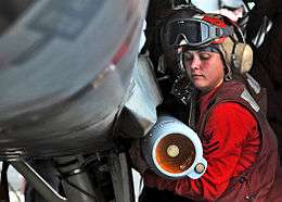 Aviation Ordnanceman loading a missile