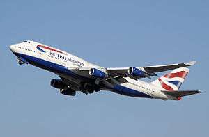 A British Airways 747-400 in white, blue and red livery during takeoff with its landing gear retracting.