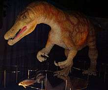 Replica dinosaur and fish in a darkened room