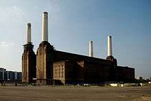 Photo of a large building with four tall chimneys.