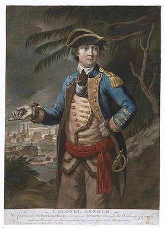 Arnold is shown wearing a military uniform: blue coat over buff waistcoat and trousers, red waistband, tricorner hat.  In the background a town is visible, as are trees that look something like palm trees.