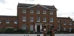 Georgian red-brick 3-storey mansion house with neoclassical pediment