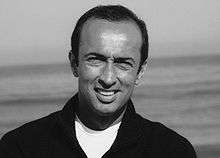 Black and white headshot of Bijan Daneshmand outside at the beach.