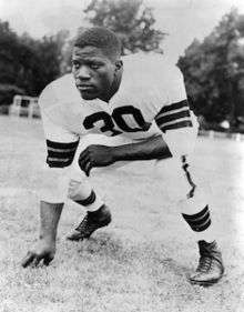 Willis shown in uniform in a lineman's stance in a 1951 publicity photo