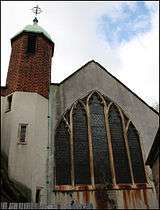 The rear of All Hallows showing the main church window and bell tower, which was used for tape storage.