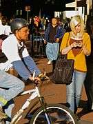 Blonde woman with tattoos texting on street.jpg