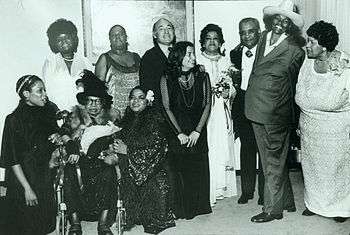 Rosetta Reitz with the performers (Carmen McRae, featured music by Adelaide Hall, Big Mama Thornton, Nell Carter, and Koko Taylor) of the Blues Is a Woman Concert at the Newport Jazz Festival at Avery Fisher Hall. Copyright Barbara Weinberg Barefield; (standing, l to r): Koko Taylor, Linda Hopkins, George Wein, Rosetta Reitz, Adelaide Hall, Little Brother Montgomery, Big Mama Thornton, Beulah Bryant; (seated, l to r): Sharon Freeman, Sippie Wallace, Nell Carter