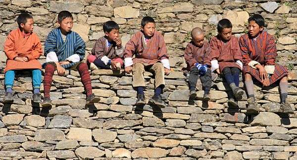 Boys at a festival wear the gho.