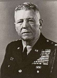 An aged Caucasian man in military uniform, with a large number of ribbons and medals