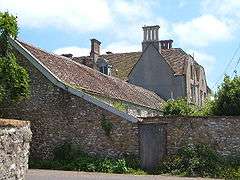 Old buildings behind a wall