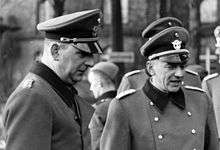 a black and white photograph of two men in uniform