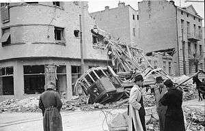 a damaged building and damaged tram