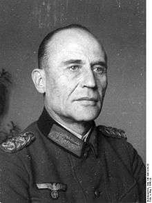 A man wearing a military uniform with an Iron Cross displayed at the front of his uniform collar.