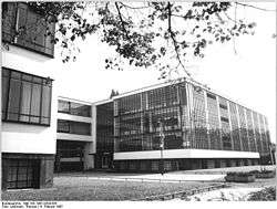 A grayscale image of a modern looking building.