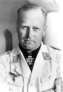 Black-and-white portrait of a man wearing a military uniform with an Iron Cross displayed at his neck.