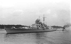 Black and white photograph of the port side of a Bismarck class battleship.