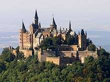 A castle atop a mountain, a very usual position to defend it from a higher position.