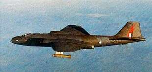 Side view of camouflaged twin-engined military jet in level flight