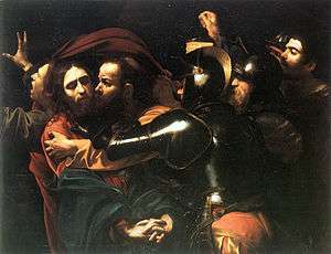 Judas kisses Jesus, and soldiers rush to seize the latter.