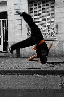 A man doing cekongfan (侧空翻; "side somersault"), a common move in Changquan.