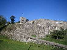 The walls of a ruined castle made of stone