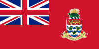 Red flag with multicoloured shield to right and Union Flag in top-left quarter.