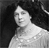 Head and shoulders shot of an Edwardian woman with dark hair, looking towards the camera