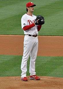 Cole Hamels standing on a pitchers mound, preparing to throw a pitch.