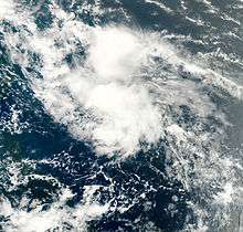 A satellite imagery depicting a disorganized mass of clouds across the central Atlantic.