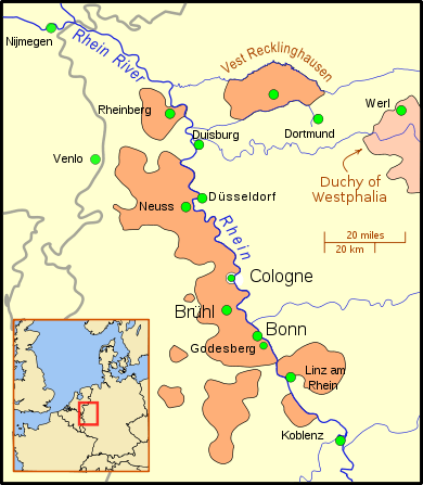 The territory is divided into nine sections; the main section borders the west bank of a wide river, and includes several important cities; other territories to the south and on the east bank of the river, are considerably smaller, and a crescent of territory south of Linz. Further north is a small section, still on the river, but separated from the main part of the territory. East of this section is "Vest Recklinghausen", and east of that is the Duchy of Westphalia. Nearby cities are, to the west, Nijmegen and Venlo, and to the east, Duisburg, Düsseldorf, and Dortmund. A big dot marks the location of Cologne, but it is distinguished from the territory by a border.