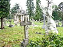 Domed Classical building, surrounded by gravestones and statues.