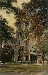 An old brick church surrounded by trees