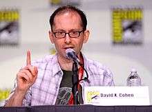 Middle-aged man with glasses speaking at a dais