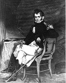 Commodore David Porter in full naval dress sitting in a chair next to a table.