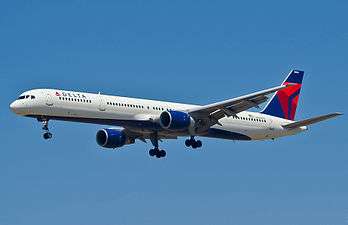 Side view of aircraft landing with extended gear.