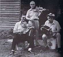 Dennis McGee and Sady Courville playing fiddle with Marc Savoy.