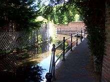 A photograph of a shallow stream flowing round an s-bend